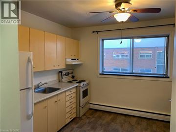 Cambridge apartment for rent - A kitchen with a refrigerator, sink, stove, and oven.