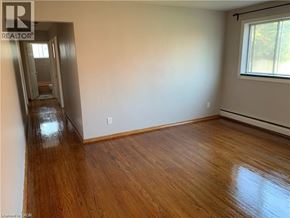 Cambridge apartment for rent - A room with wooden floors and a window.