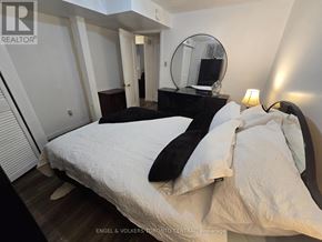 Toronto (Malvern) house for rent - A bedroom with a bed, a dresser, and a mirror.