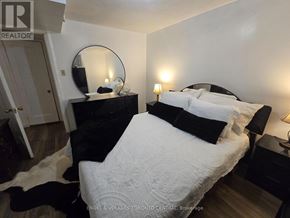 Toronto (Malvern) house for rent - A bedroom with a large bed and a mirror on the dresser.