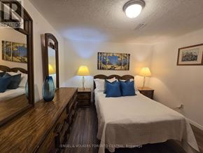 Toronto (Malvern) house for rent - A bedroom with a bed, nightstands, and a mirror.