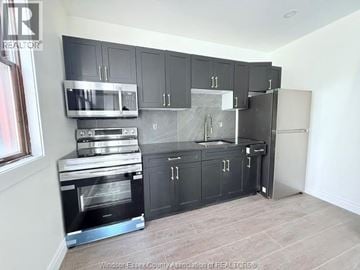 Windsor apartment for rent - A kitchen with black cabinets and stainless steel appliances.