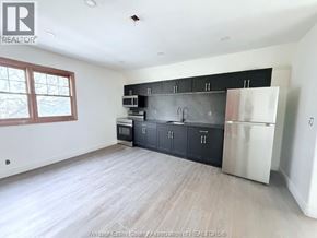 Windsor apartment for rent - A kitchen with black cabinets and a stainless steel refrigerator.
