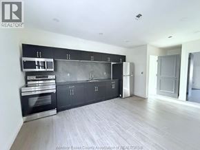 Windsor apartment for rent - A kitchen with black cabinets and stainless steel appliances.