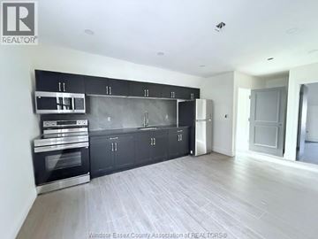 Windsor apartment for rent - A kitchen with black cabinets and stainless steel appliances.
