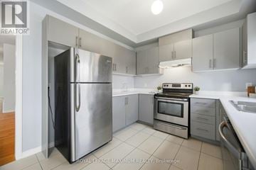 Vaughan (Elder Mills) house for rent - A modern kitchen with a stainless steel refrigerator and oven.