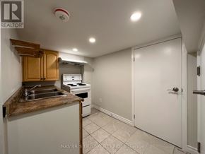 Toronto (Caledonia-Fairbank) house for rent - A kitchen with a sink, stove, and cabinets.