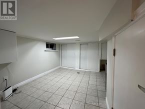 Toronto (Caledonia-Fairbank) house for rent - A white room with tiled flooring and a door on the right.