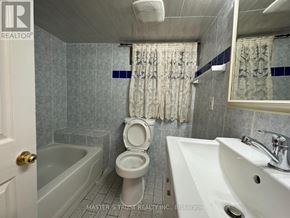 Toronto (Caledonia-Fairbank) house for rent - A bathroom with a toilet, sink, and bathtub.