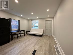 Toronto (Caledonia-Fairbank) house for rent - A room with a white sofa and a black cabinet.