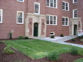 Newport News apartment for rent - a brick building with a lawn in front of it