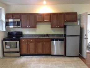 Newport News apartment for rent - a kitchen with stainless steel appliances and wooden cabinets