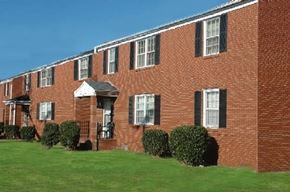Newport News apartment for rent - a red brick building with a green lawn
