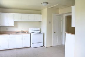 Newport News apartment for rent - an empty kitchen with white appliances and white cabinets