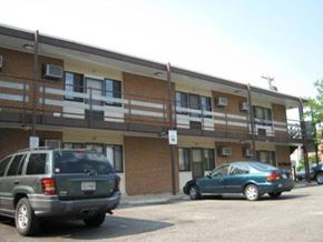 Newport News apartment for rent - two cars parked in a parking lot in front of a building