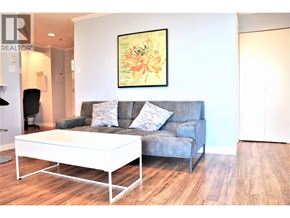 Richmond apartment for rent - A grey couch with a white coffee table in front of it.