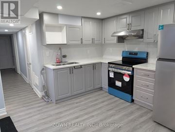 Brampton (Brampton South) house for rent - A kitchen with white cabinets and a blue island.