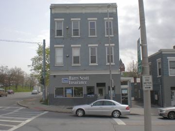 Poughkeepsie apartment for rent - A silver car is parked in front of a Barry Scott Insurance office.