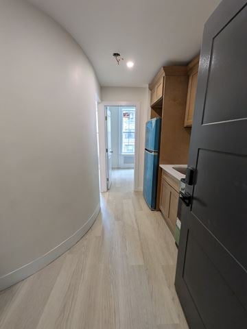 New York apartment for rent - A kitchen with a refrigerator, cabinets, and a counter.