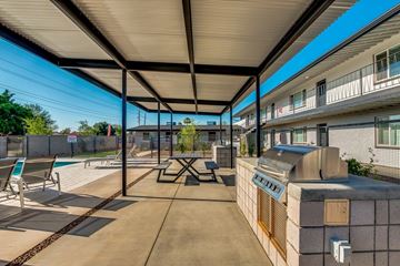 Phoenix apartment for rent - A patio with a table and chairs under a roof.