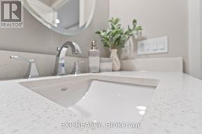 For rent in Perth - A bathroom sink with a round mirror above it.