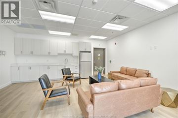 Amherstburg apartment for rent - A living room with a brown couch and a chair.