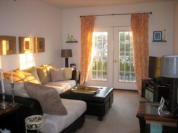 Metuchen apartment for rent - A living room with a white couch and a coffee table.