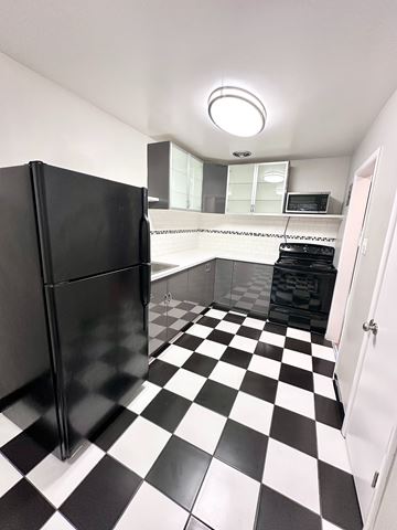 Denver apartment for rent - A black and white checkered floor in a kitchen.