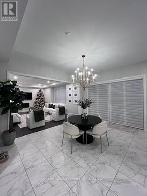 Aurora (Aurora Highlands) house for rent - A modern dining room with a black table and white chairs.