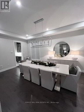 Aurora (Aurora Highlands) house for rent - A modern dining room with a long table set for a meal.