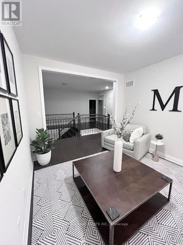 Aurora (Aurora Highlands) house for rent - A living room with a coffee table and a large letter M on the wall.