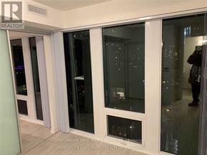 Toronto (Church-Yonge Corridor) condo for rent - A room with glass doors and a man standing in the doorway.