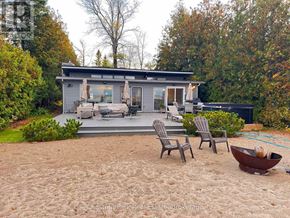 Collingwood house for rent - A house with a grey roof and a grey patio with two chairs and a table.