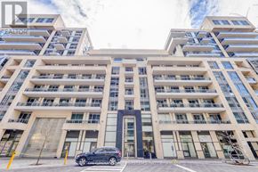 Richmond Hill (Langstaff) condo for rent - A modern multi-story building with a car parked in front.