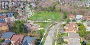 Toronto (Westminster-Branson) house for rent - A bird's eye view of a residential neighborhood with houses and a park.