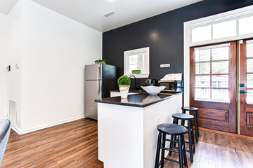 Atlanta apartment for rent - A kitchen with a black refrigerator and white countertops.