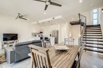 Scottsdale townhouse for rent - A modern living room with a grey sofa and a wooden dining table.