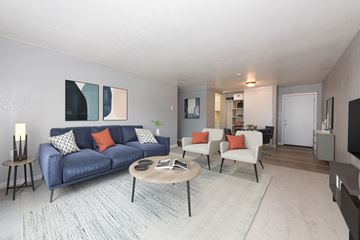 East Palo Alto apartment for rent - A living room with a blue couch and orange pillows.