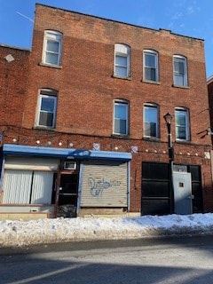Poughkeepsie apartment for rent - A red brick building with a closed garage door.