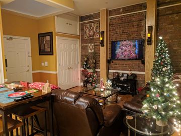 Morristown apartment for rent - A living room with a brown leather couch and a Christmas tree.