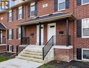 Windsor house for rent - A red brick house with black shutters and a white door.