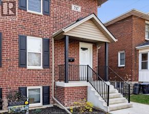 Windsor house for rent - A red brick house with a white door and black railings.