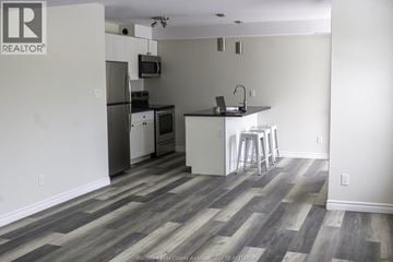 Windsor house for rent - A kitchen with a refrigerator, microwave, and stove.
