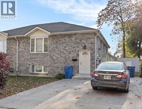 Windsor fourplex for rent - A house with a car parked in front of it.