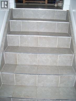 Windsor fourplex for rent - A set of stairs with grey tiles.