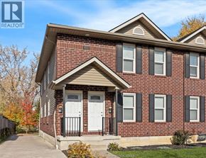 Windsor duplex for rent - A house with a brick facade and a white door is for sale.