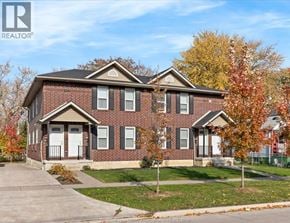 Windsor fourplex for rent - A brick house with a white door and windows.