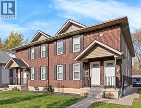 Windsor duplex for rent - A brick house with a white door and windows.