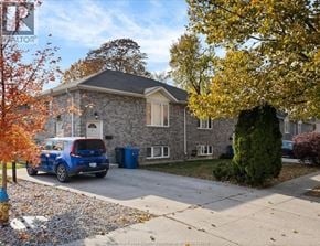 Windsor fourplex for rent - A house with a blue car parked in front.