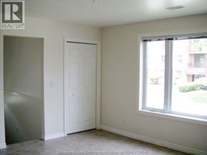Windsor fourplex for rent - A room with a door, a window and a wall.